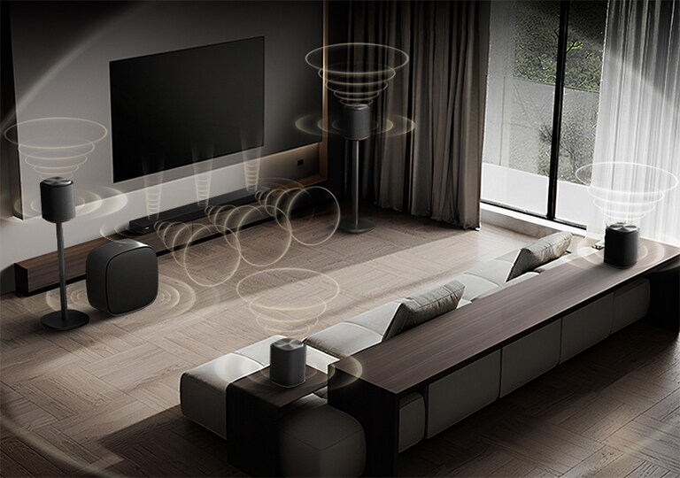 LG QNED evo AI Mini LED QNED85 featuring Sound Suite with DAFC (Dolby Atmos FlexConnect) shows a wide room with different kinds of speakers placed around the room showing how flexible and customizable Sound Suite can be.