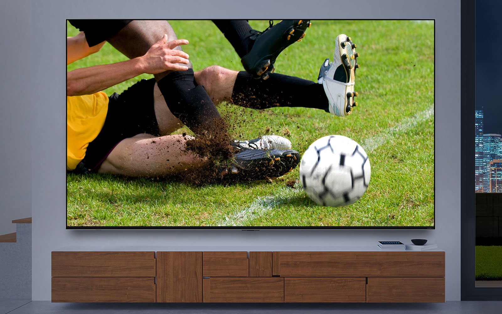 A TV screen displaying a close up of a soccer player tackling other player gets larger. Then the screen changes to cinematic image of space station as the interior changes to dark. At last, the screen changes once again to a game scene that a knight fighting against a dragon. (play the video)