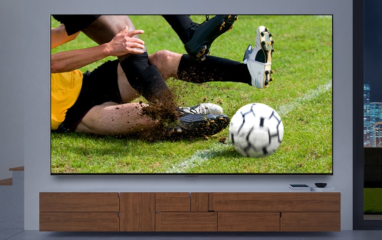 A TV screen displaying a close up of a soccer player tackling other player gets larger. Then the screen changes to cinematic image of space station as the interior changes to dark. At last, the screen changes once again to a game scene that a knight fighting against a dragon. (play the video)