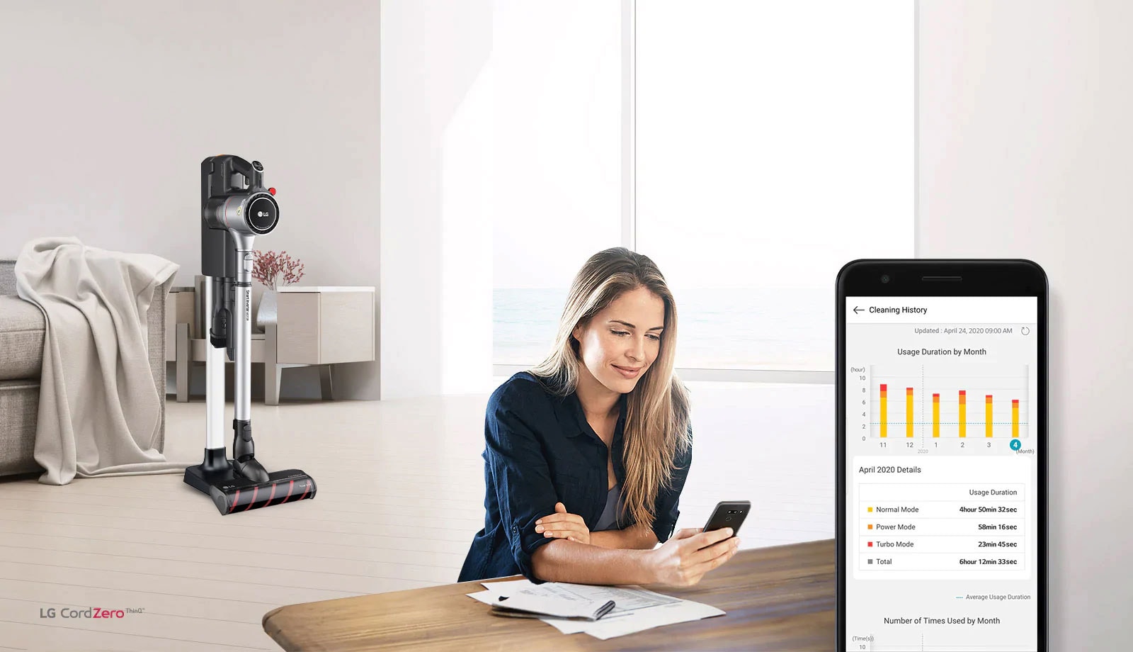 The vacuum in the charging stand is in a living room in the background with a woman looking at her phone in the foreground. An image of the phone screen shows the cleaning history of her product.