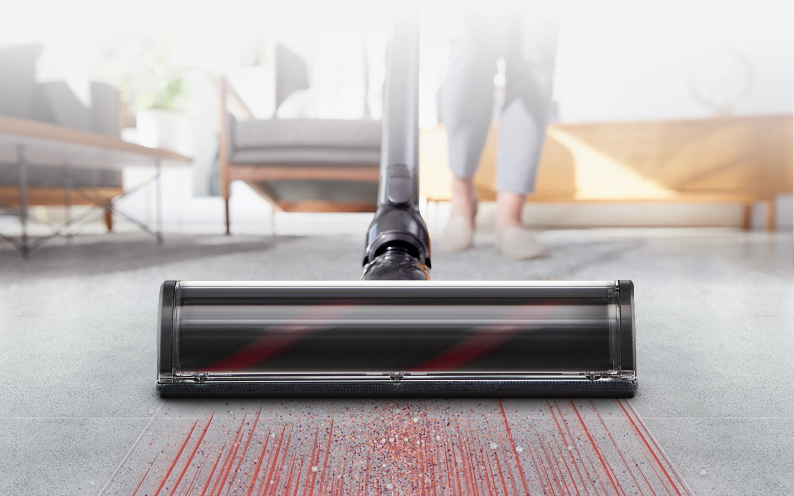The head of the vacuum cleaner is quickly sucking up dust on the carpet showing strong suction capability.