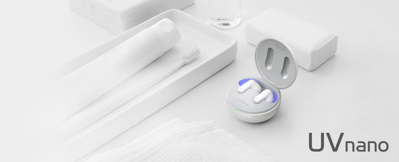 Image of TONE Free placed with objects representing cleanliness such as soap, toothbrush and toothpaste. The image contains a copy of Refresh Your BUDS and a UVnano logo.