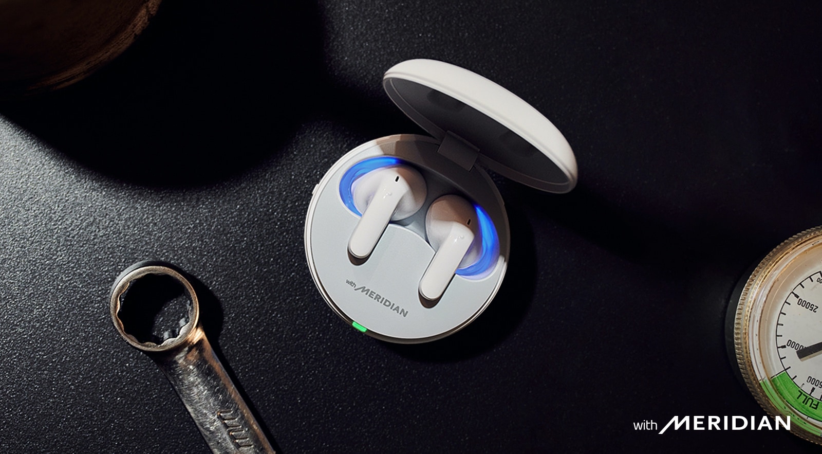 An aerial view of the T90 earbuds inside the cradle, sitting on a tabletop.