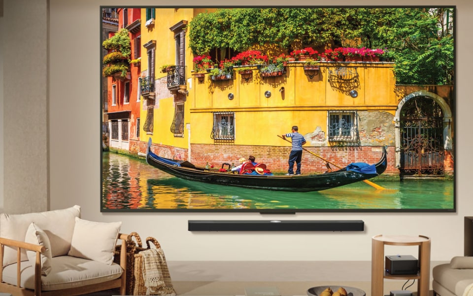 LG OLED TV displaying vivid Venice canal scene with gondola, delivering lifelike colors in a modern living room.