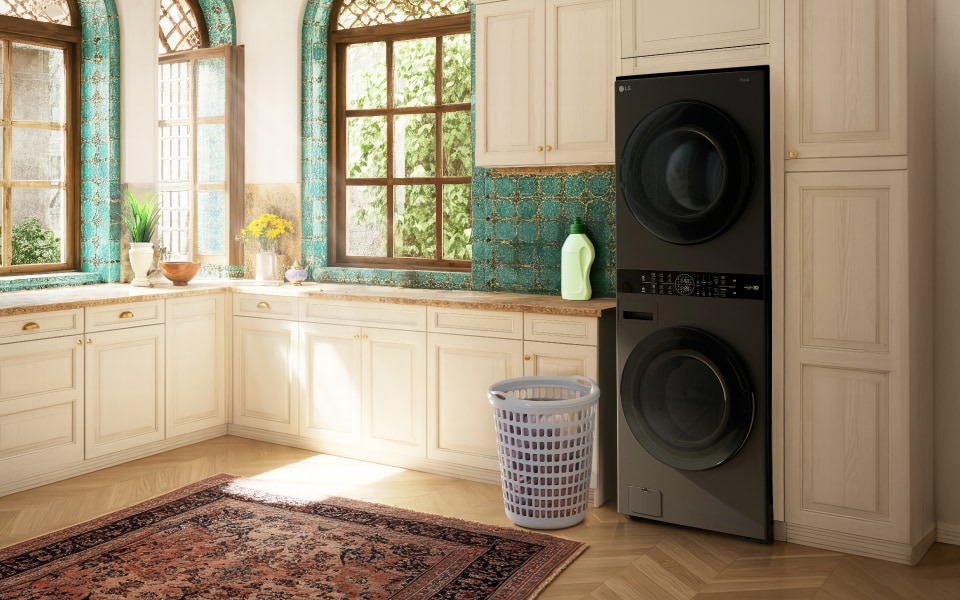 Laundry room with LG WashTower, laundry basket, cream cabinets, and teal tile window accents.