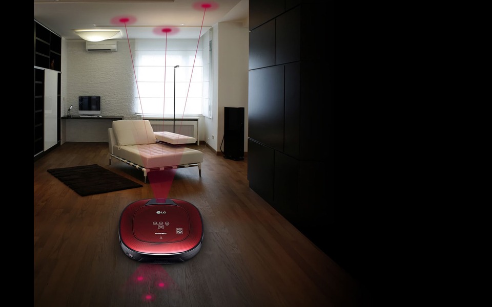 LG vacuum cleaning modern living room with sofa and computer.