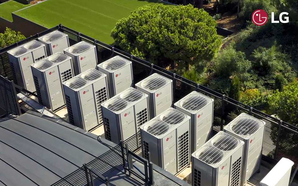 An aerial view of multiple LG HVAC outdoor air conditioning units installed in rows on a building rooftop.