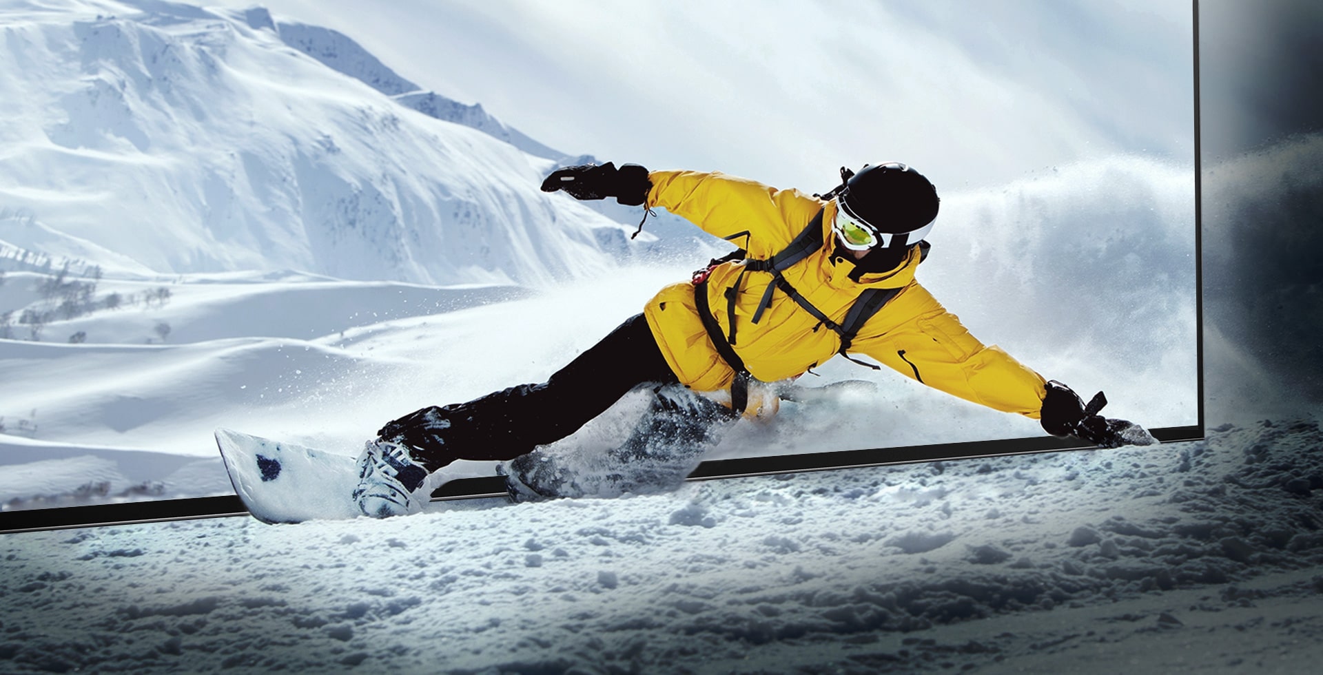 A snowboarder leaning through the screen of the LG OLED television while the snow comes to life in the room.