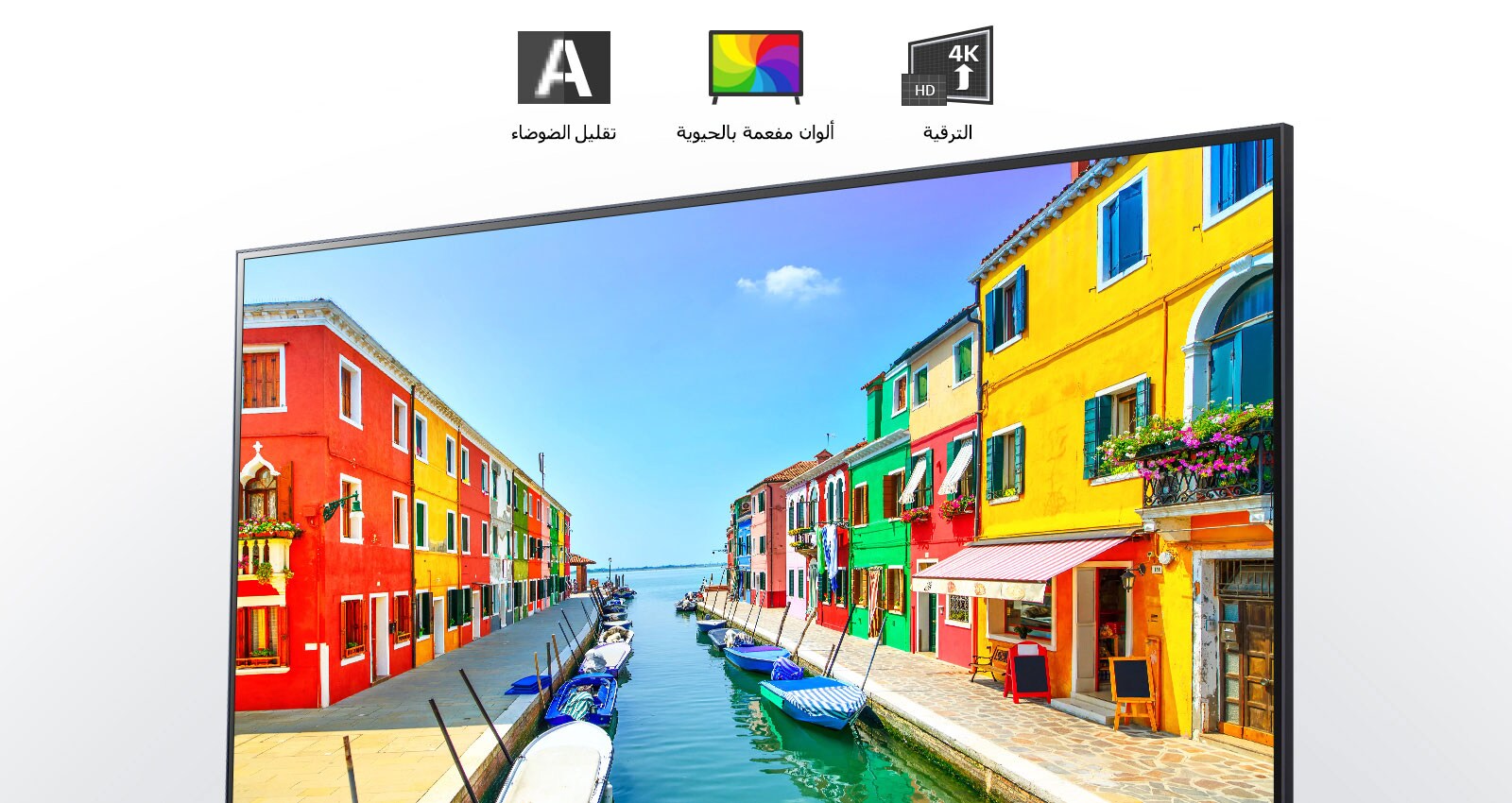 شاشة تلفزيون تعرض مشهدا لمدينة ساحلية تتميز فيها البنايات بطلاء متعدد الألوان كما ترسو القوارب الصغيرة في ميناء طويل وضيق. 