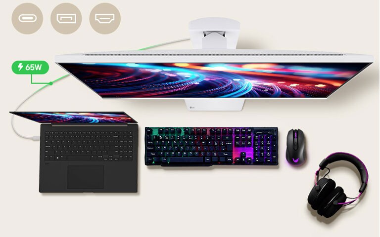 A 32-inch gaming monitor is positioned in the center of the desk, with various IT devices placed around it. 