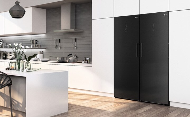 The freezer is shown at an angle seamlessly fitting in with the cabinets in a modern kitchen.