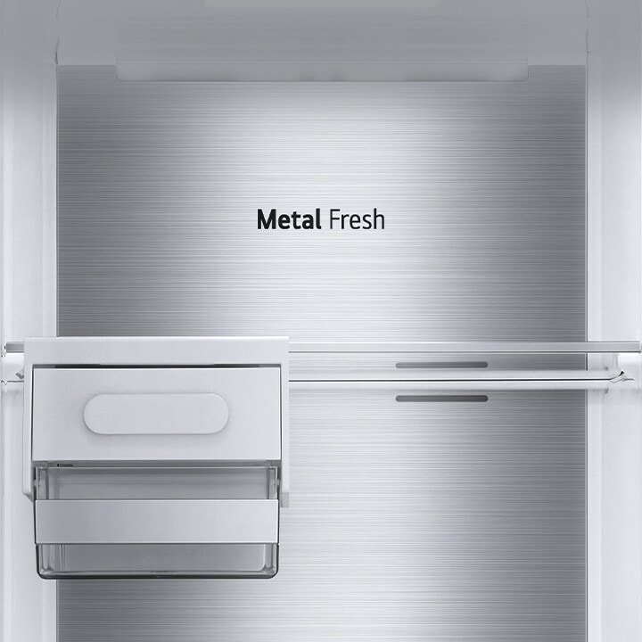 The interior of the fridge is shown empty with the ice rack and shelf in place and the back which is labeled "Metal Fresh".	