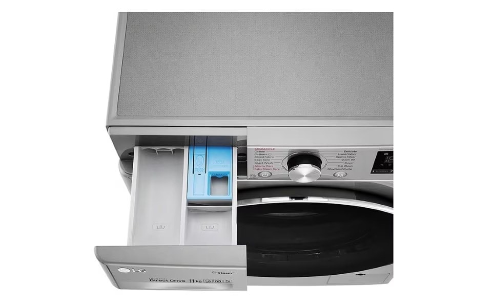 A close-up overhead view of an LG washing machine with its detergent drawer pulled open.