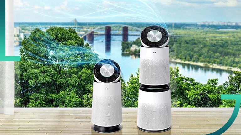 A smiling woman holds a Christmas present while her partner kisses her on the cheek