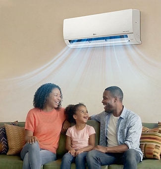 A happy family on a sofa enjoying fast, powerful cooling airflow from a wall-mounted air conditioner.	