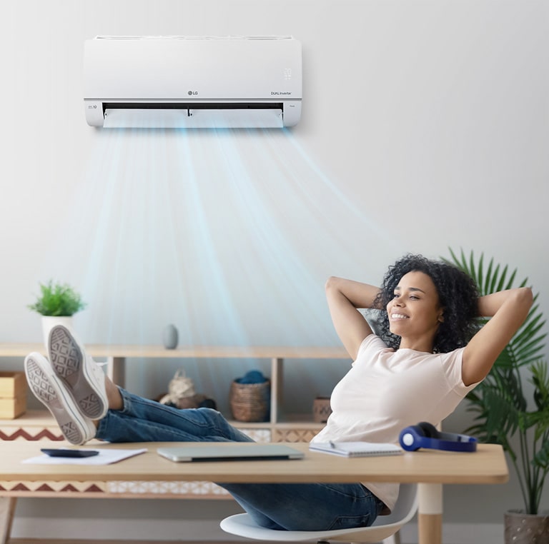 A woman who closes her eyes and relaxes under a quiet air conditioner.