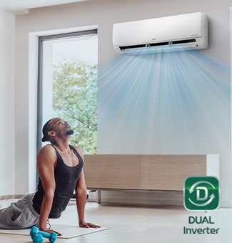A man exercising under an air conditioner that is fast cooling the space.