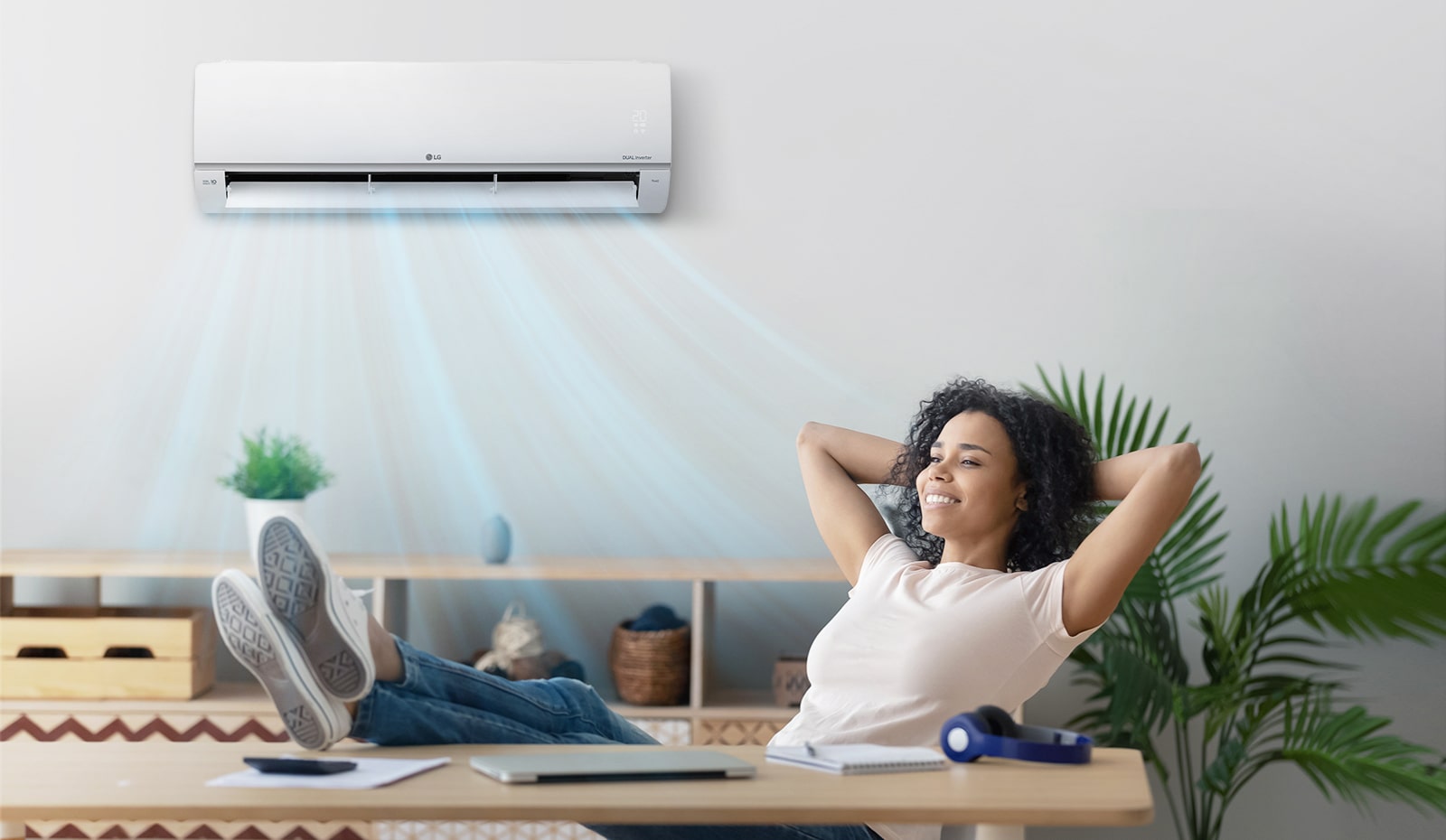 A woman who closes her eyes and relaxes under a quiet air conditioner.