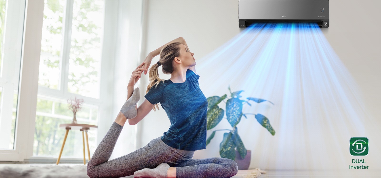 A woman is stretching on the floor. In the background is the air conditioner and blue air flows out over the woman and the room. The Dual Inverter logo is in the bottom right corner.