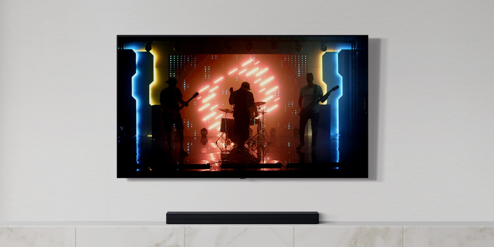 There is a TV and a soundbar in white living room. A group of band playing instruments and singing song on a TV screen. (play the video)