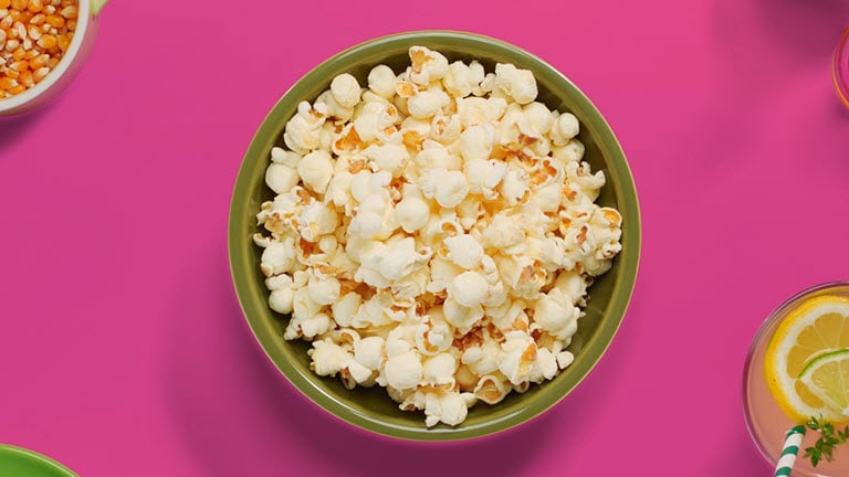 The video shows that a bowl of popcorn is being cooked faster by  LG NeoChef™ than the other one being cooked with conventional microwave oven.