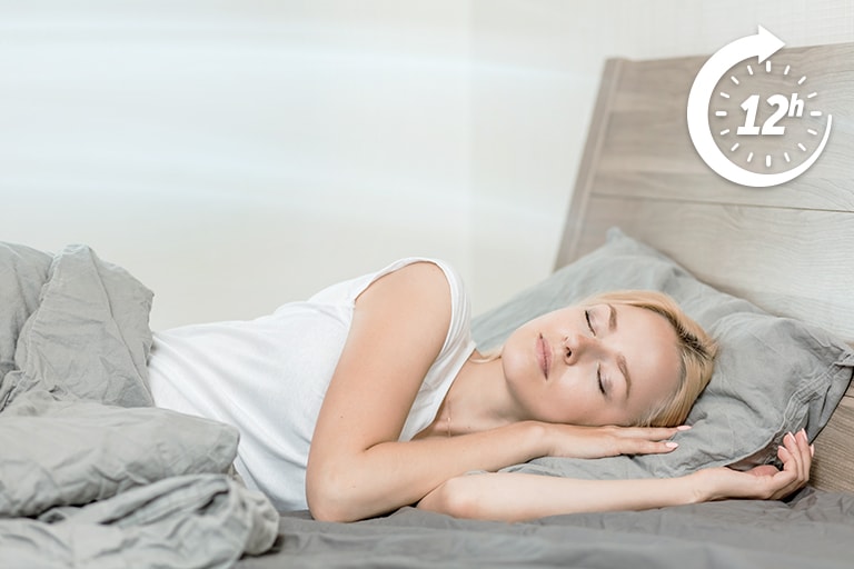 An over-sleeping woman relaxedly, feeling the breeze from the air conditioner