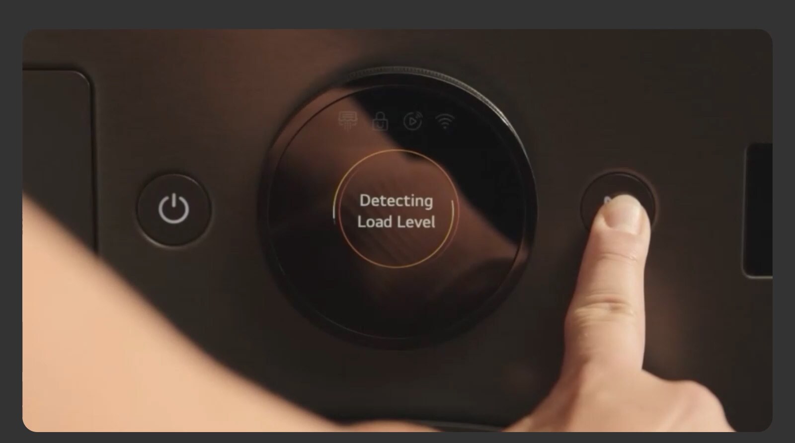 A close-up image of a dryer control panel as a finger presses an operation button on the right.
