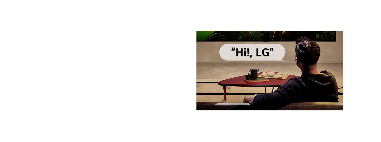 Person in their living room. Speech bubble around them showing how they're interacting with their LG TV just by saying, Hi LG.