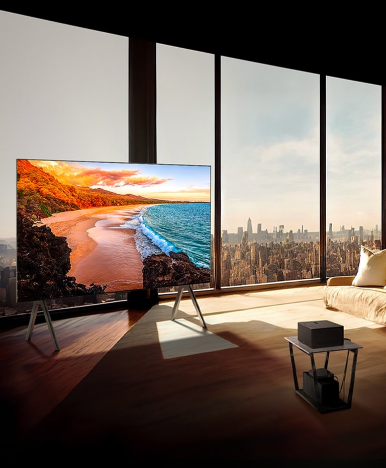 LG SIGNATURE OLED M4 on a stand in front of floor-to-ceiling windows in a sunny, modern apartment.