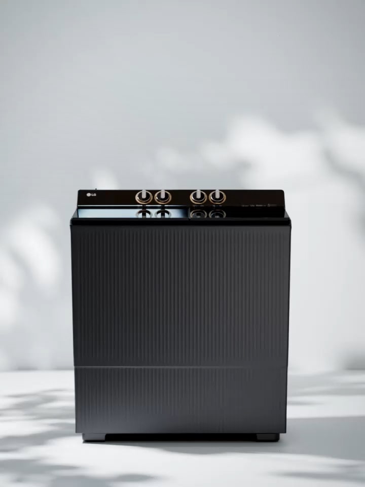 Front view of a modern black top-loading washing machine with control dials on top, displayed on a clean white background.