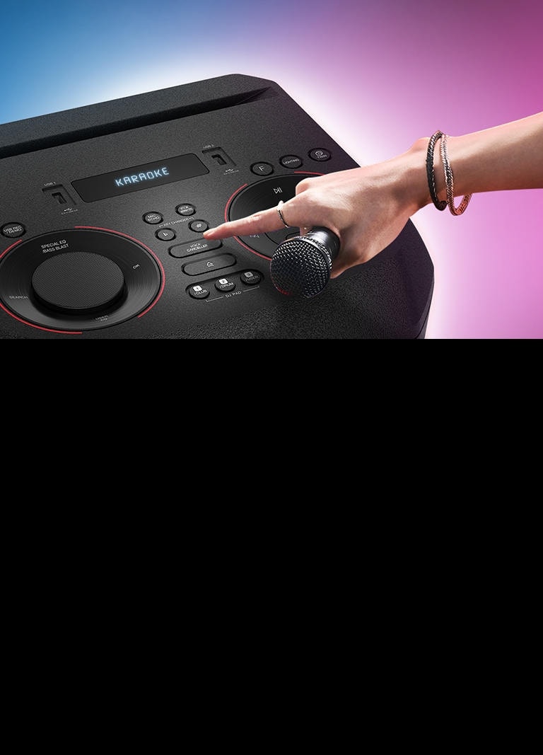A hand holding a microphone tries to press the Voice canceller button on the top of LG XBOOM.