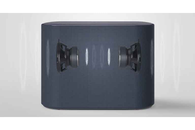 A subwoofer is placed on a white floor. Two components inside the subwoofer are shown.