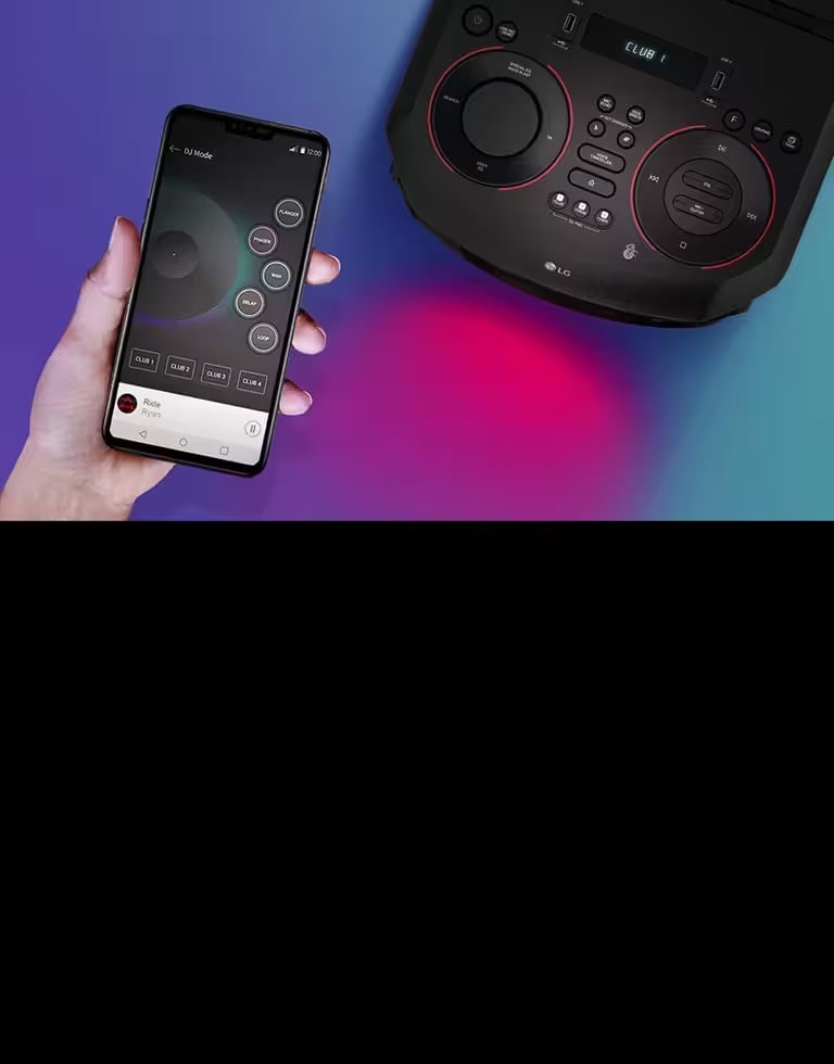 A hand holding a smartphone next to a top view of LG XBOOM.