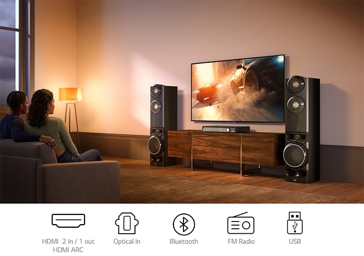 Home entertainment setup with dual tower speakers connected to TV for movies and streaming content