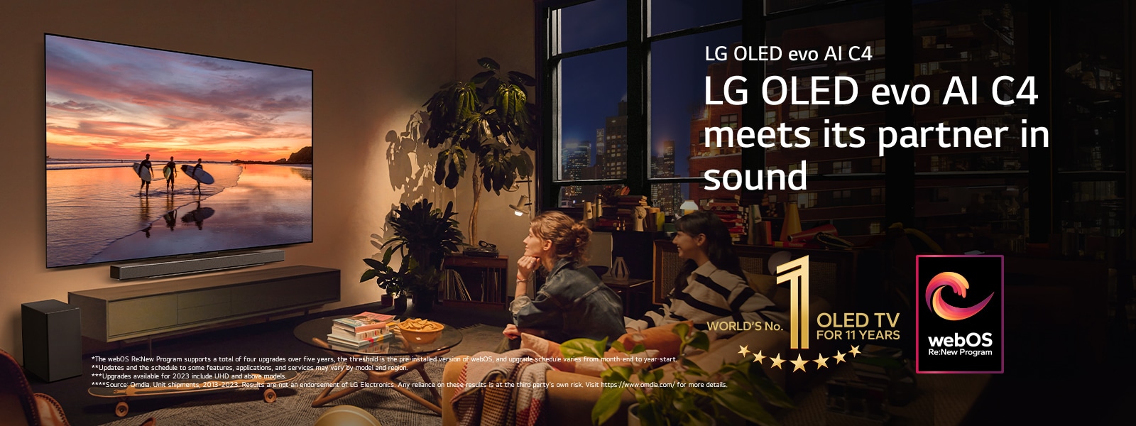 LG OLED evo C4 TV mounted on the wall of a cosy evening living room and an LG soundbar mounted just below it. On the TV, a beach at sunset with silhouttes of three surfers is displayed. Two women sit on the sofa facing and leaning towards the TV and soundbar. The "World's number 1 OLED TV for 11 Years" emblem and the "webOS Re:New Program" logo are in the image. A disclaimer reads: "The webOS Re:New Program supports a total of four upgrades over five years, the threshold is the pre-installed version of webOS, and upgrade schedule varies from month-end to year-start." "Updates and the schedule to some features, applications, and services may vary by model and region."  "Upgrades available for 2023 include UHD and above models." "Source: Omdia. Unit shipments, 2013 to 2023. Results are not an endorsement of LG Electronics. Any reliance on these results is at the third party’s own risk. Visit https://www.omdia.com/ for more details."