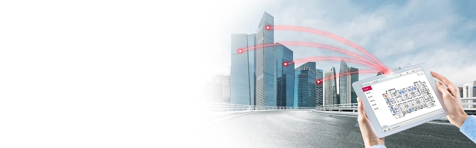 A person holds a tablet displaying a control solution. Four red lines extend from the tablet, connecting to buildings on the left.