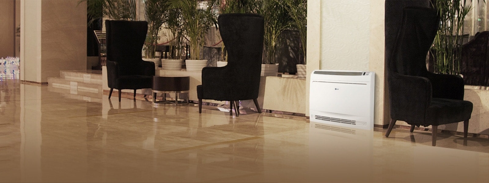 In a hallway styled area featuring a marble floor, three long-backed black chairs are arranged with an LG Single Split Console displayed between them.