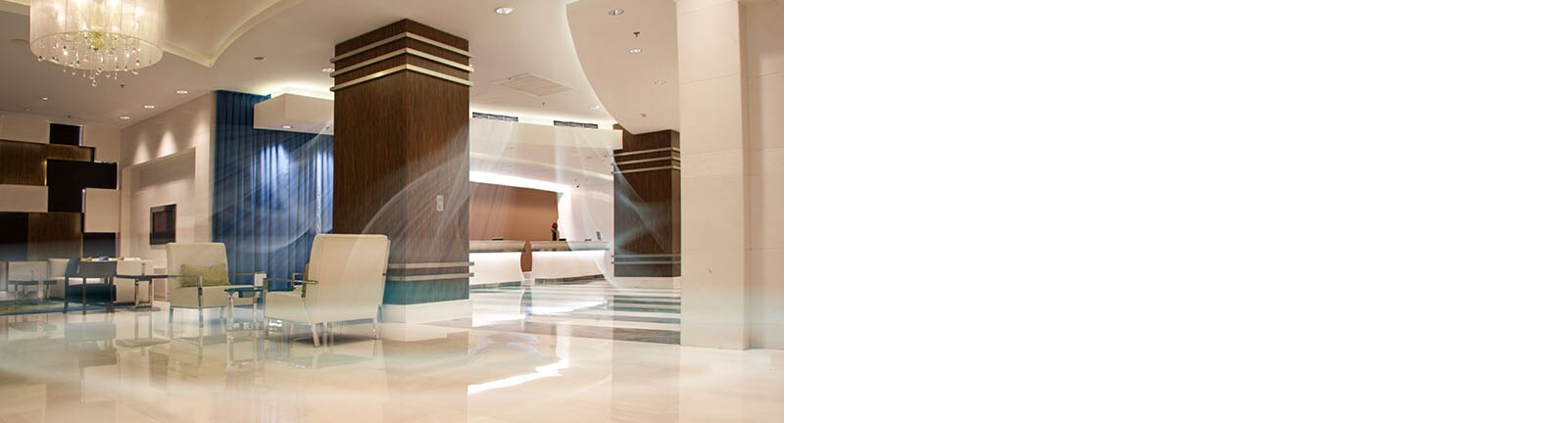 An image of a spacious hotel lobby with air conditioning on.