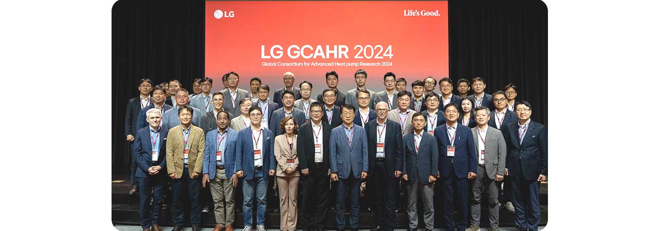 LG Global Consortium for Advanced Heat pump Research 2024 event with business professionals on stage, discussing heat pump innovations.