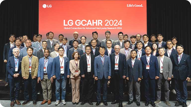 LG Global Consortium for Advanced Heat pump Research 2024 event with business professionals on stage, discussing heat pump innovations.