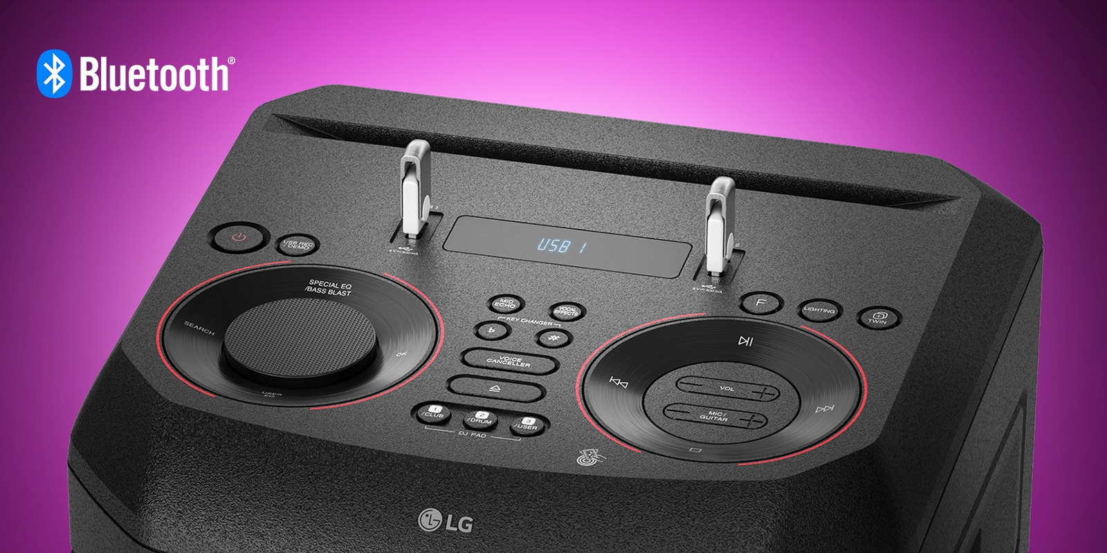 A closeup view of controls on top , with two USBs plugged in. A Bluetooth logo is shown in the upper left corner.