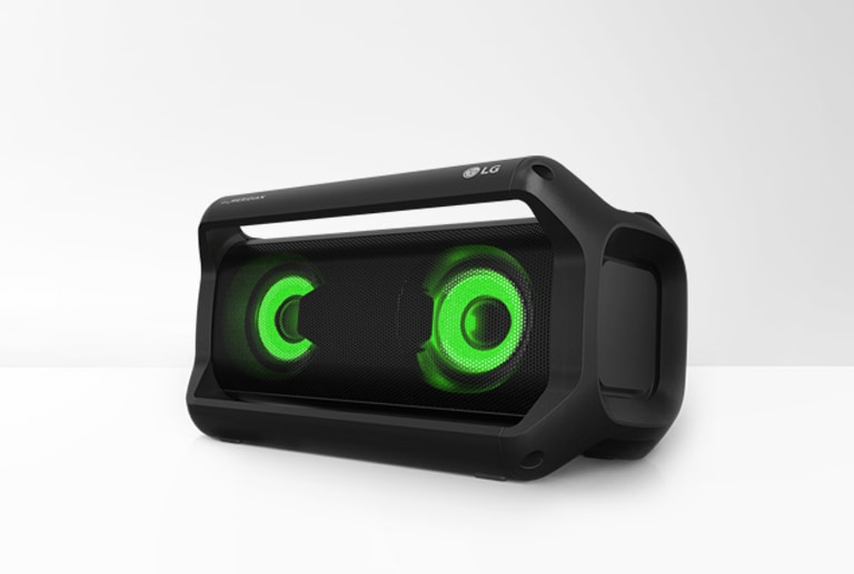 On a white background, an right end view of LG XBOOM Go PK5 is showing green lighting.