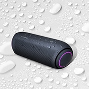 LG XBOOM Go PL5 20W Portable Bluetooth Speaker with Meridian Audio Technology, On a white background, LG XBOOM Go is facing up to the left. There are water droplets on and underneath LG XBOOM Go., PL5, thumbnail 5