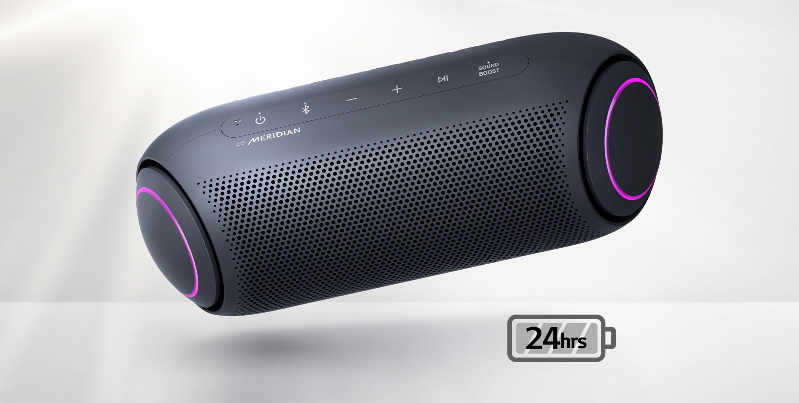 LG XBOOM Go tilts to the left and floats in the air. The woofer lighting is magenta. 