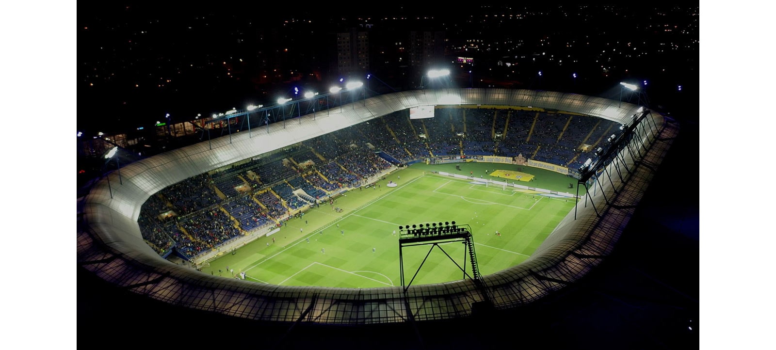 An aerial view of a stadium with a video play button