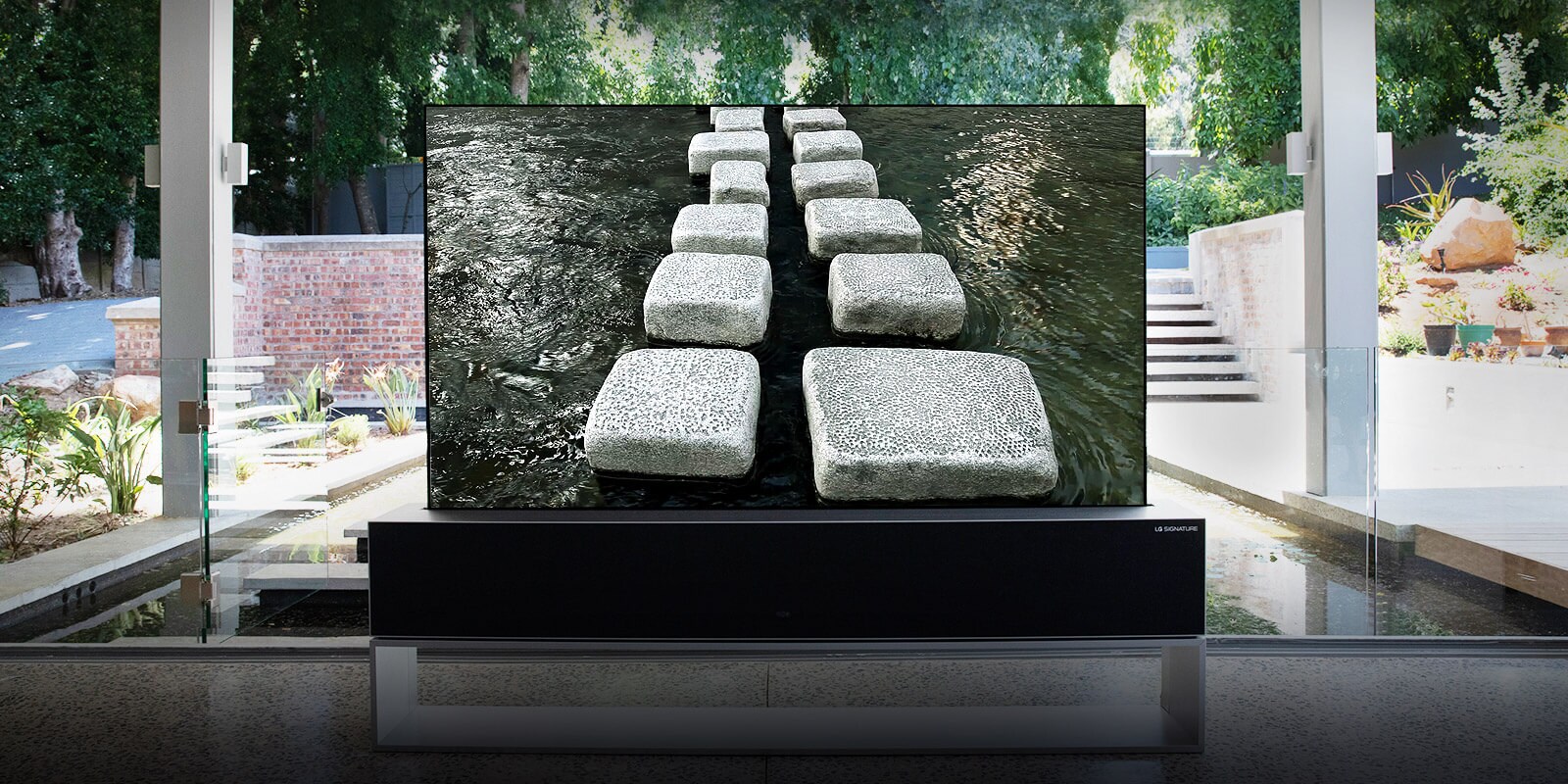Rollable TV, situated in front of the pond of a luxurious house, showing step-stone bridge (scroll down the page)