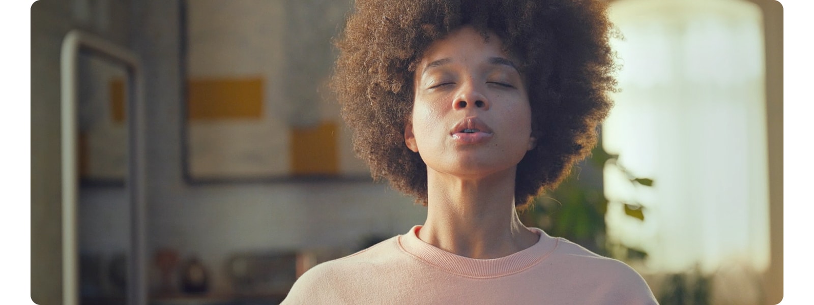 Woman airing out the house and relaxing in clean air