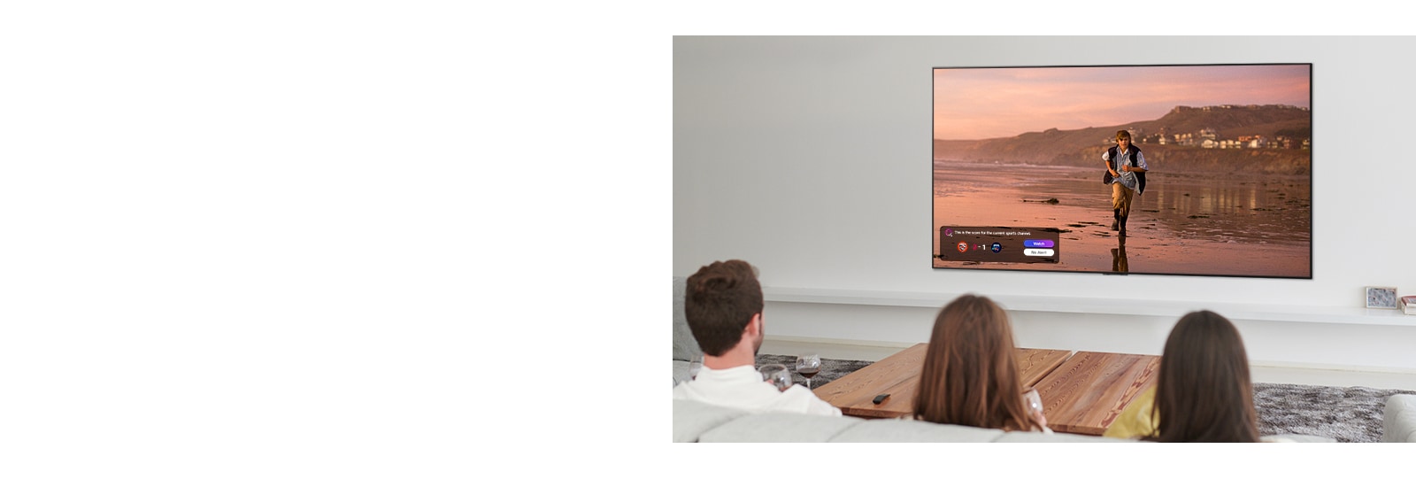 Three people watching TV screen showing a scene from a fantasy movie with a Sports Alert