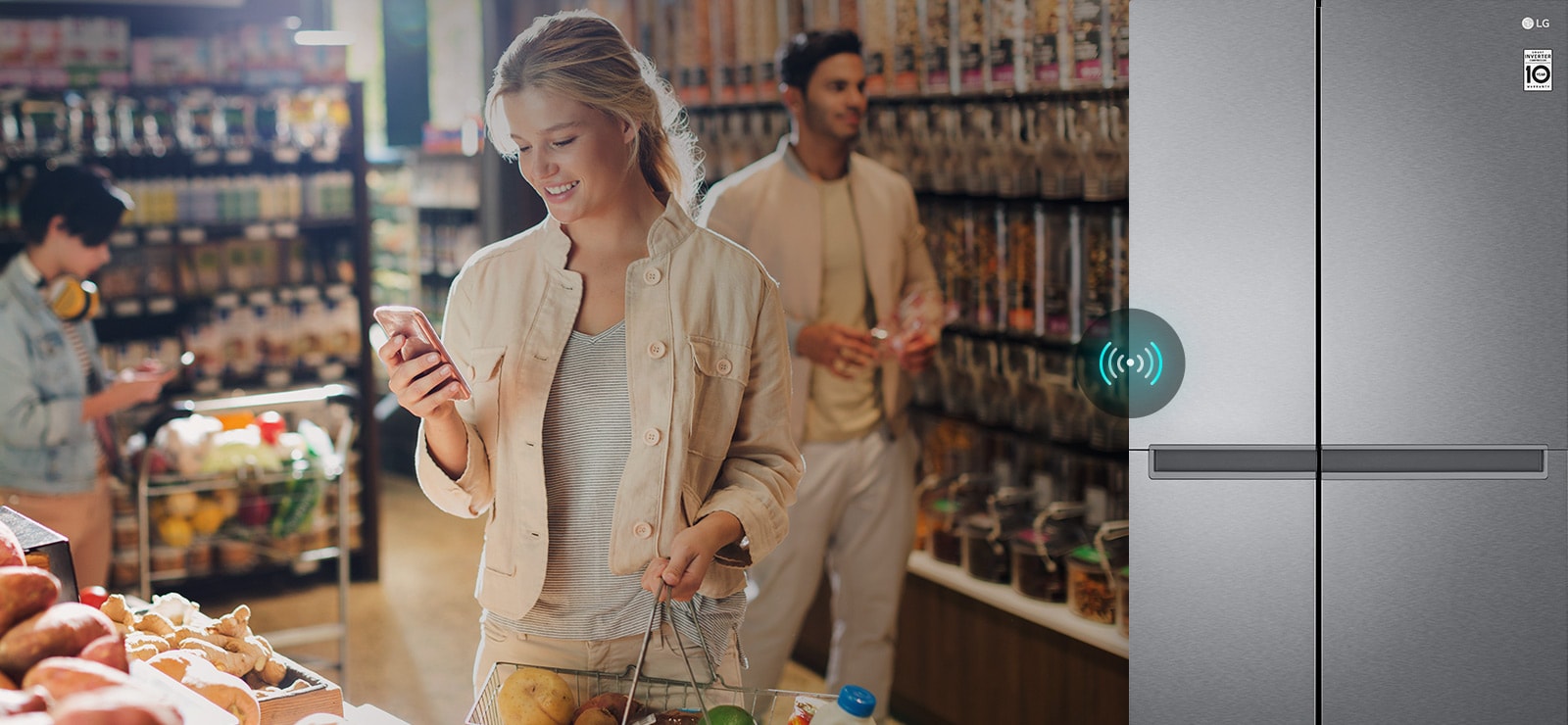 Image on the left shows a woman standing in a grocery store looking at her phone. Image on the right shows the refrigerator front view. In the center of the images is an icon to show connectivity between the phone and refrigerator.