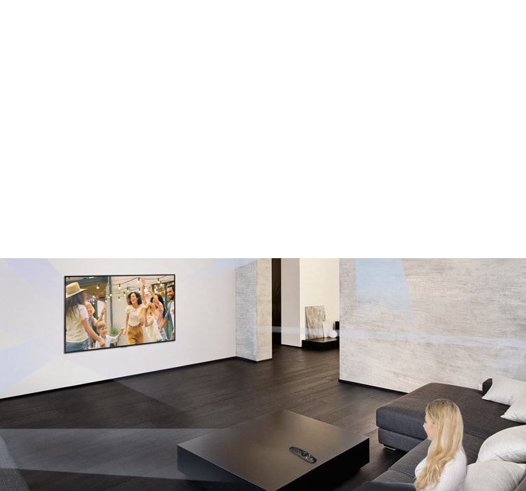 Woman in large and minimalistic living room watching people dancing on TV